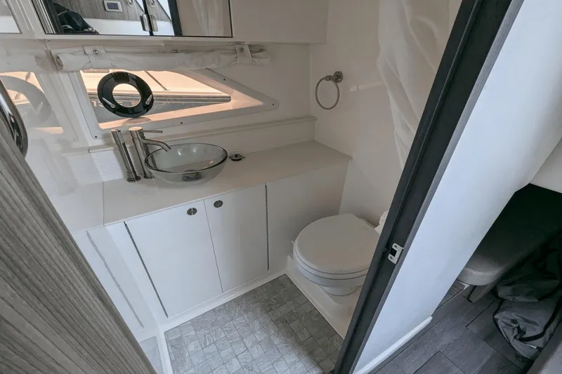 Slide: The Image of 2023 Sea Ray Sundancer 320 Outboard bathroom with modern sink and toilet. - 17