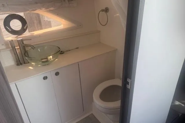 Slide: The Image of 2023 Sea Ray Sundancer 320 Outboard bathroom with modern sink and toilet. - 27