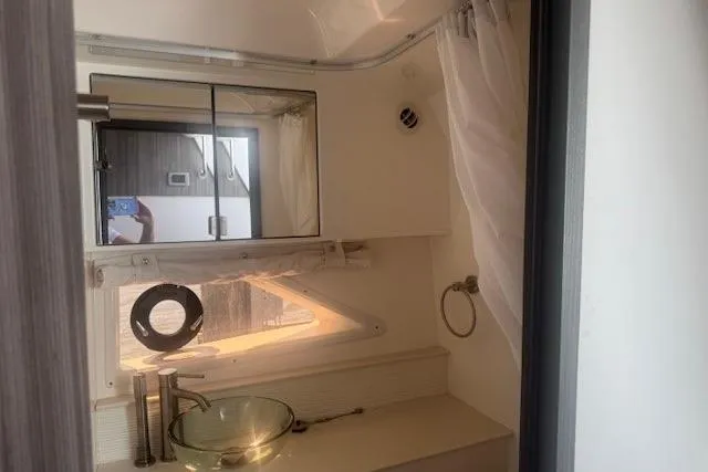 Slide: The Image of 2023 Sea Ray Sundancer 320 Outboard bathroom with modern fixtures and glass sink. - 28