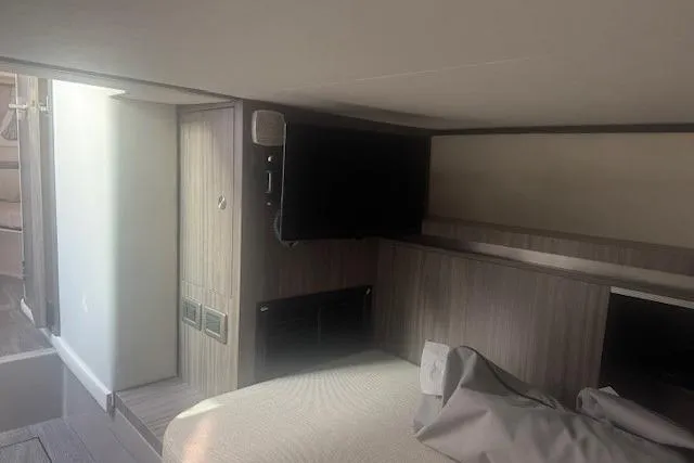 Slide: The Image of 2023 Sea Ray Sundancer 320 Outboard cabin interior with modern design and TV. - 29