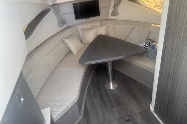 Slide: The Image of 2023 Sea Ray Sundancer 320 Outboard cabin with modern seating and triangular table. - 32