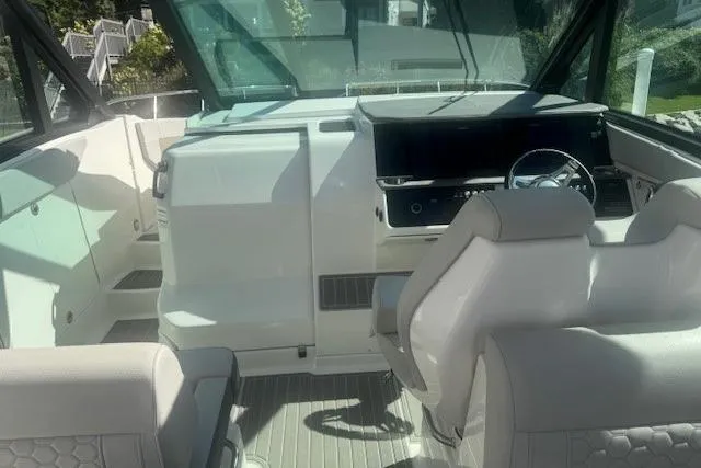 Slide: The Image of 2023 Sea Ray Sundancer 320 Outboard cockpit with modern helm and seating. - 36