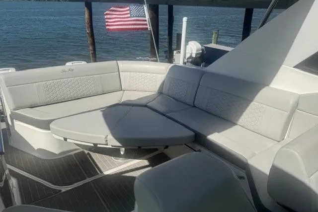Slide: The Image of 2023 Sea Ray Sundancer 320 Outboard, luxurious seating area with American flag in background. - 39