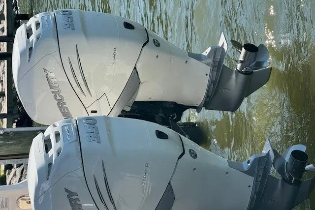 Slide: The Image of Twin Mercury outboard engines on a 2023 Sea Ray Sundancer 320, docked on water. - 4