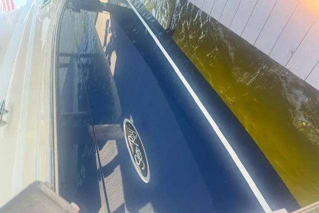 Slide: The Image of 2023 Sea Ray Sundancer 320 Outboard docked, showcasing sleek blue hull design. - 46