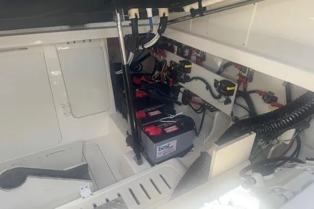 Slide: The Image of 2023 Sea Ray Sundancer 320 Outboard engine compartment with batteries and wiring. - 48