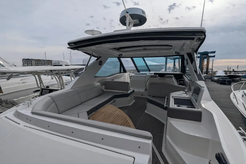 Slide: The Image of 2023 Sea Ray Sundancer 320 Outboard, spacious cockpit with modern seating and sleek design. - 6