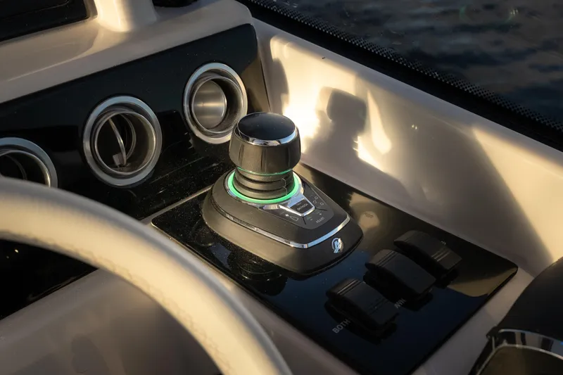 Slide: The Image of Control panel of 2026 Fountain 39 DX boat with joystick and switches. - 13