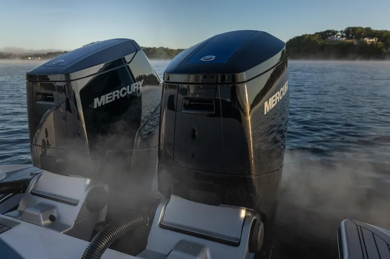 Slide: The Image of Twin Mercury outboard engines on a 2026 Fountain 39 DX boat, misty water backdrop. - 16