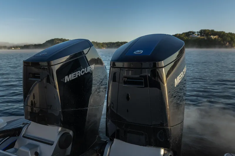 Slide: The Image of Twin Mercury outboard engines on a 2026 Fountain 39 DX boat, cruising on a serene lake. - 18
