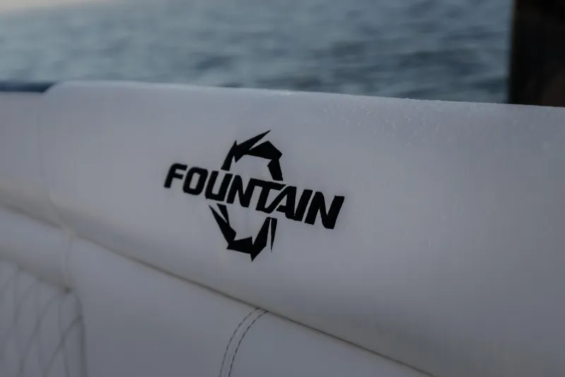 Slide: The Image of 2026 Fountain 39 DX boat logo on white upholstery with ocean background. - 19