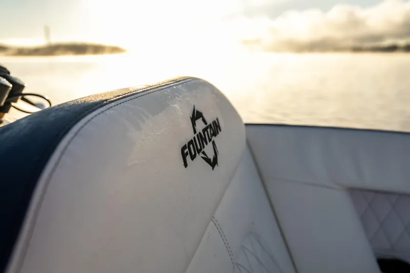 Slide: The Image of Fountain 39 DX boat seat with logo, 2026 model, against a serene water backdrop. - 23