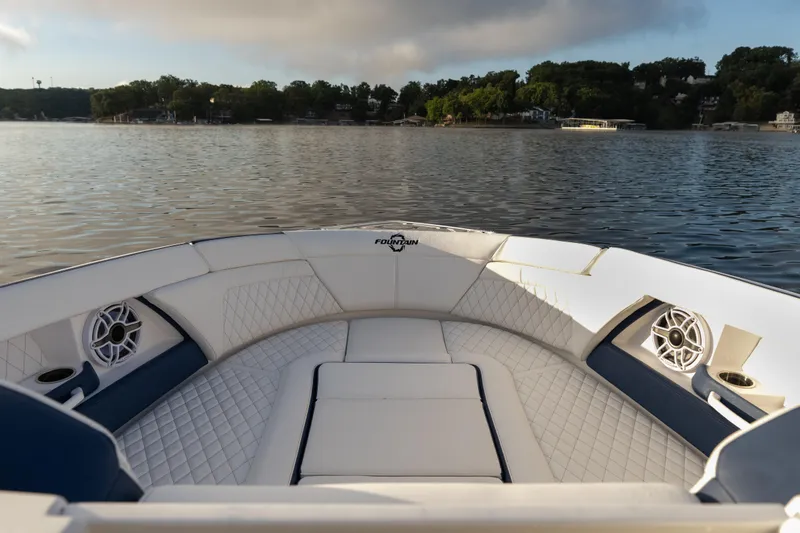 Slide: The Image of Luxurious 2026 Fountain 39 DX boat interior with quilted seating on a serene lake. - 26