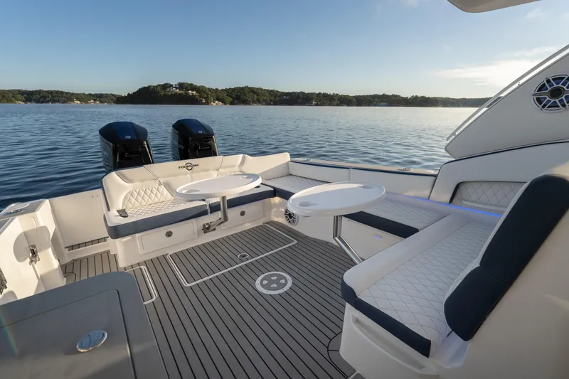 Slide: The Image of Luxurious 2026 Fountain 39 DX boat interior with seating and tables on a serene lake. - 27