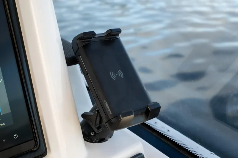 Slide: The Image of Smartphone holder on 2026 Fountain 39 DX boat dashboard, overlooking water. - 32