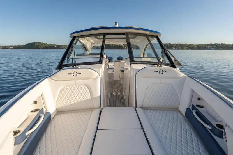 Slide: The Image of Luxurious 2026 Fountain 39 DX boat interior with white seating on a serene lake. - 36