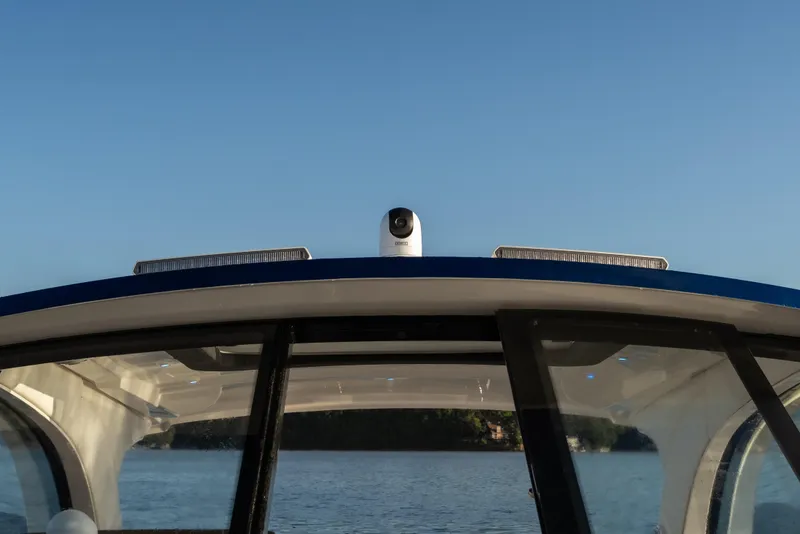 Slide: The Image of 2026 Fountain 39 DX boat roof with camera, clear sky, and water backdrop. - 37