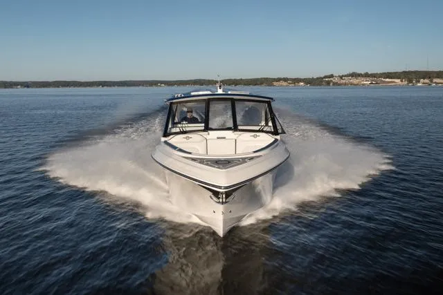 Slide: The Image of 2026 Fountain 39 DX boat cruising on a calm lake under clear skies. - 4