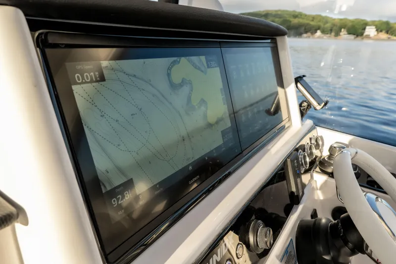 Slide: The Image of 2026 Fountain 39 DX boat dashboard with GPS navigation screen on a sunny day. - 40