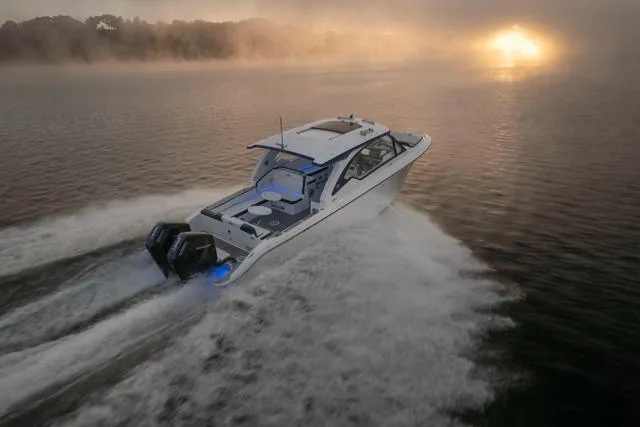 Slide: The Image of 2026 Fountain 39 DX boat cruising at sunrise on misty water. - 7