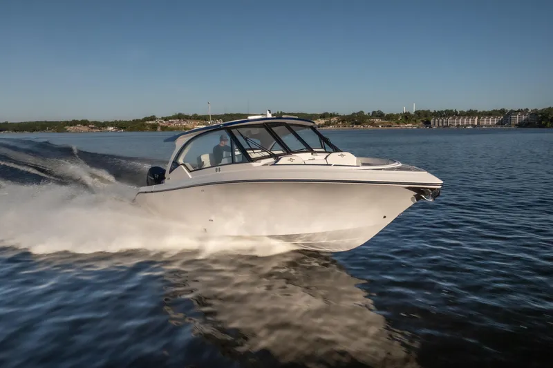 Slide: The Image of 2026 Fountain 39 DX boat cruising on a calm lake under clear blue skies. - 8
