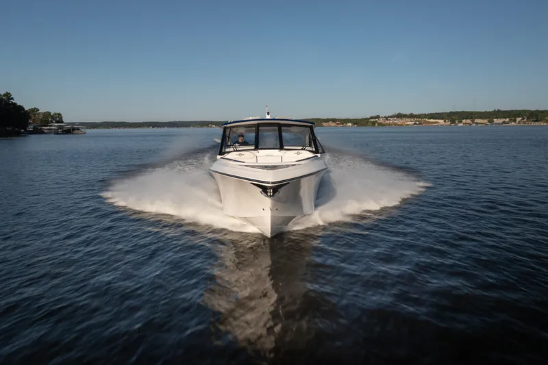 Slide: The Image of 2026 Fountain 39 DX boat cruising on a serene lake under a clear blue sky. - 9