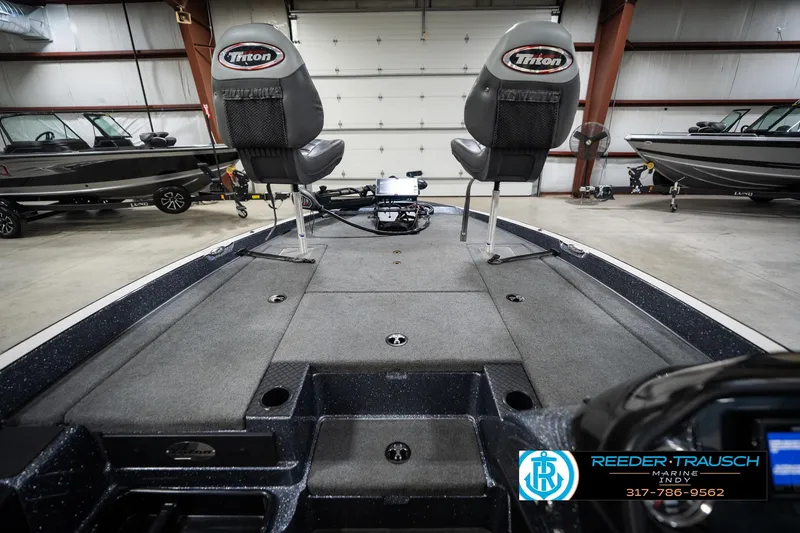 Slide: The Image of 2015 Triton 18TRX boat interior with dual seats in a showroom setting. - 15