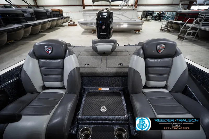 Slide: The Image of 2015 Triton 18TRX boat interior with dual seats in a showroom. - 17