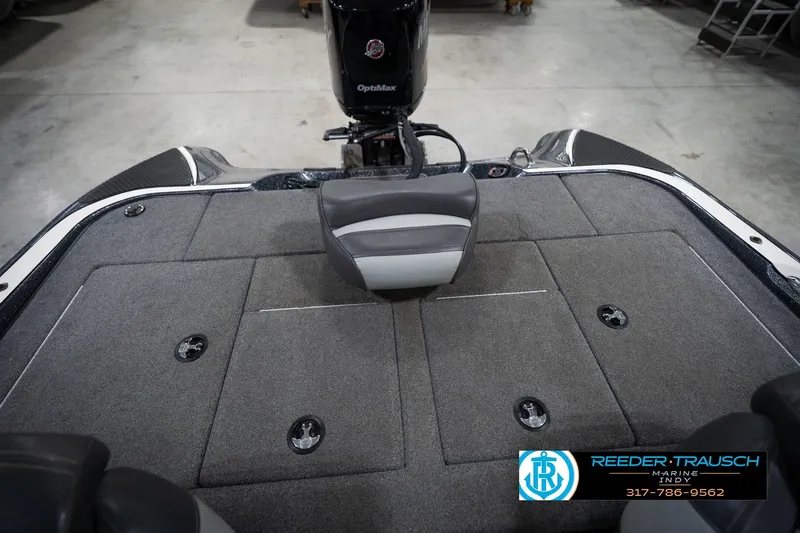Slide: The Image of 2015 Triton 18TRX boat interior with OptiMax engine, gray carpet, and seating. - 18