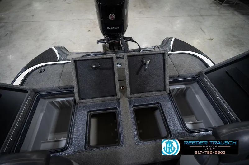 Slide: The Image of 2015 Triton 18TRX boat interior with open storage compartments and OptiMax engine. - 20