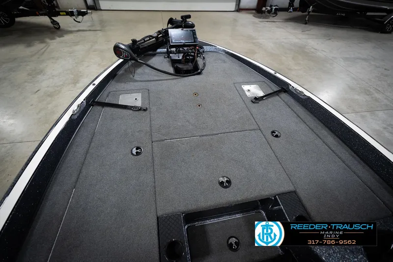 Slide: The Image of 2015 Triton 18TRX boat deck with trolling motor and control panel in a showroom. - 22