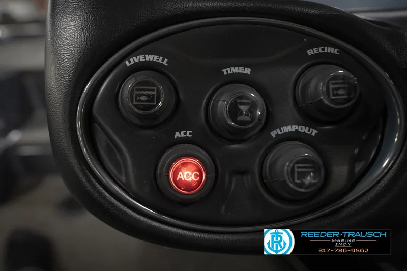 Slide: The Image of Control panel of a 2015 Triton 18TRX boat with various switches and buttons. - 27