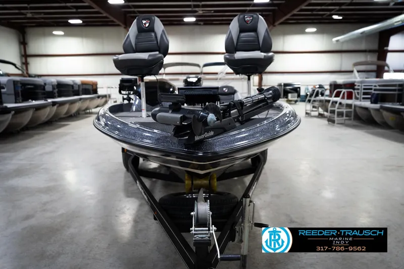 Slide: The Image of 2015 Triton 18TRX boat in showroom, featuring dual seats and trolling motor. - 3