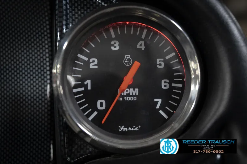 Slide: The Image of Triton 18TRX 2015 tachometer displaying RPM, with carbon fiber background. - 31