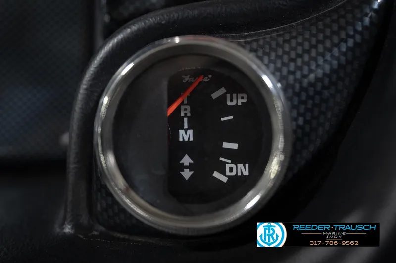 Slide: The Image of 2015 Triton 18TRX trim gauge with carbon fiber background, Reeder Trausch Marine logo. - 32
