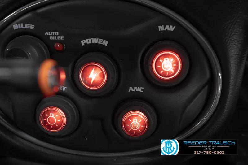 Slide: The Image of Control panel of a 2015 Triton 18TRX boat with illuminated switches. - 33