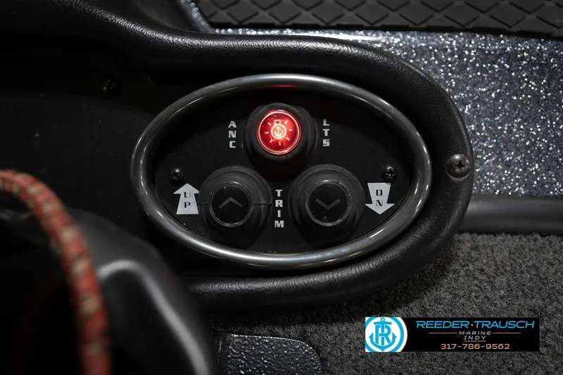 Slide: The Image of Control panel of a 2015 Triton 18TRX boat with trim and light switches. - 36