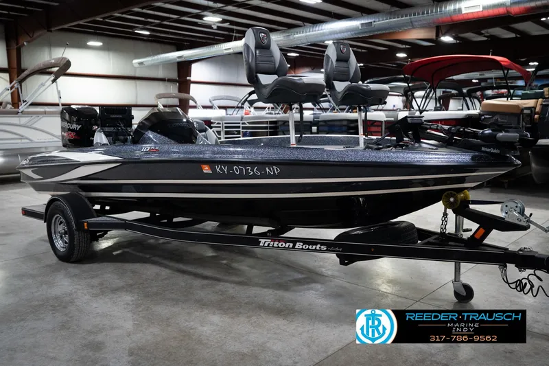 Slide: The Image of 2015 Triton 18TRX boat in showroom, featuring dual seats and Mercury engine. - 4