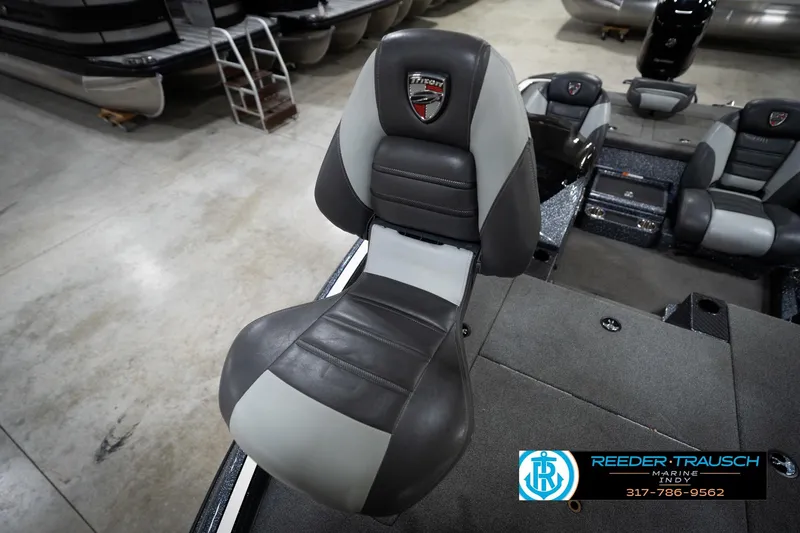 Slide: The Image of 2015 Triton 18TRX boat seat in showroom, featuring gray and black upholstery. - 40