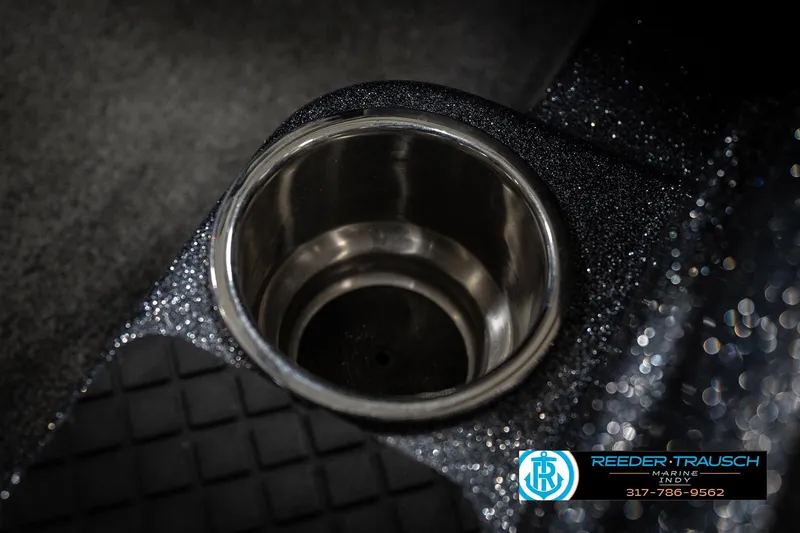 Slide: The Image of Cup holder in 2015 Triton 18TRX boat, featuring metallic finish and textured surface. - 43