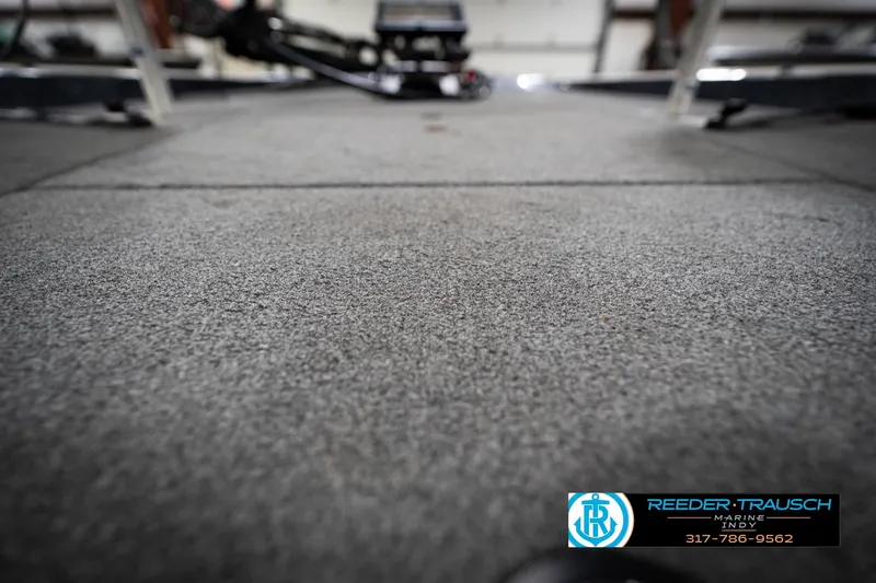 Slide: The Image of Carpeted deck of a 2015 Triton 18TRX boat, featuring Reeder Trausch Marine logo. - 44