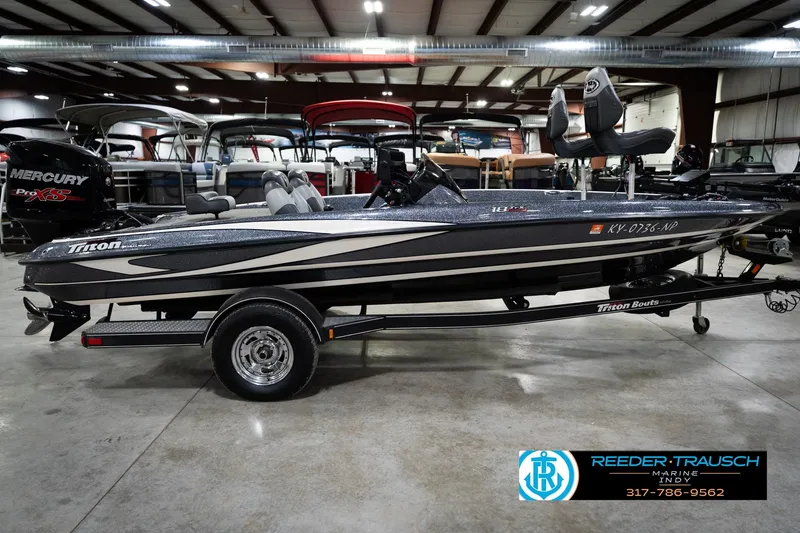 Slide: The Image of 2015 Triton 18TRX bass boat with Mercury Pro XS engine in showroom. - 5