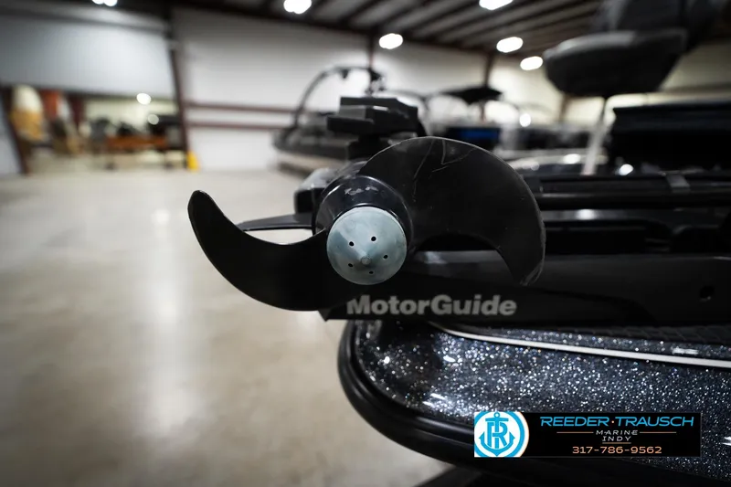 Slide: The Image of Close-up of a 2015 Triton 18TRX boat's MotorGuide propeller in a showroom. - 51