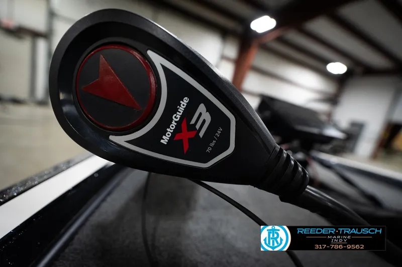 Slide: The Image of Triton 18TRX 2015 with MotorGuide X3 trolling motor in a warehouse setting. - 52