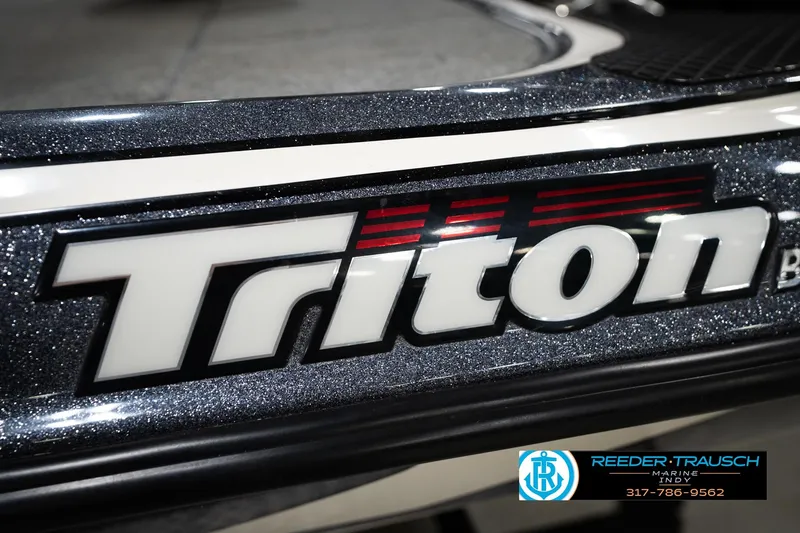 Slide: The Image of Close-up of 2015 Triton 18TRX boat logo with Reeder-Trausch Marine contact details. - 54