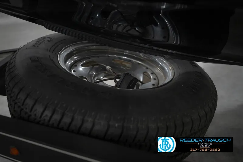 Slide: The Image of 2015 Triton 18TRX trailer tire with chrome rim, Reeder Trausch Marine logo visible. - 57