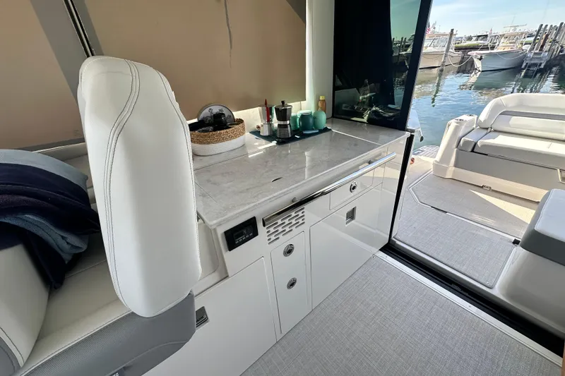 Slide: The Image of Luxurious interior of 2023 Regal 36 Grande Coupe yacht with sleek design and waterfront view. - 10