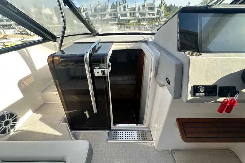 Slide: The Image of 2023 Regal 36 Grande Coupe interior with modern helm and cabin entrance. - 17