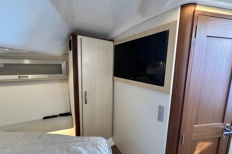 Slide: The Image of Interior of 2023 Regal 36 Grande Coupe with TV and wooden cabinetry. - 19