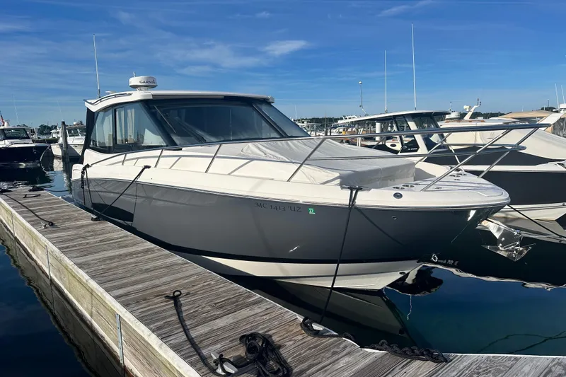 Slide: The Image of 2023 Regal 36 Grande Coupe docked at marina, showcasing sleek design and modern features. - 2